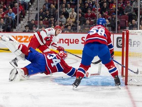 Carolina Hurricanes' Brady Skjei shoots the puck past diving Montreal Canadiens goalie Jake Allen and defenceman David Savard for a goal during second period of National Hockey League game in Montreal Tuesday March 7, 2023.