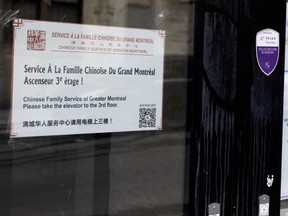 A sign in English, French and Chinese on a door of the Chinese Family Service