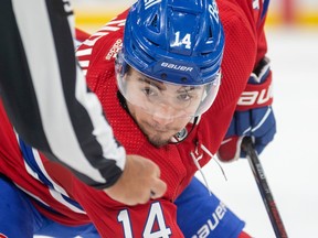 Canadiens' Nick Suzuki concentrates on the linesman's hand as he takes a faceoff during the first period of a National Hockey League game against the New York Rangers in Montreal Thursday March 9, 2023.