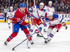 Montreal Canadiens' Jesse Ylonen shoots the puck while being checked by New York Rangers' K'Andre Miller during the first period of a National Hockey League game in Montreal Thursday March 9, 2023.