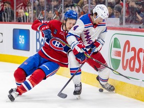 Canadiens' Michael Pezzetta leans on New York Rangers' Braden Schneider during the third period of a National Hockey League game in Montreal Thursday March 9, 2023.