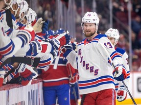 New York Rangers' Alexis Lafreniere high-fives teammates after scoring during the first period of a National Hockey League game against the Montreal Canadiens in Montreal Thursday March 9, 2023.