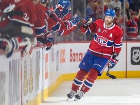 Canadiens' Josh Anderson gets high-fives from teammates on the bench after scoring during the second period of a National Hockey League game against the New York Rangers in Montreal Thursday March 9, 2023.