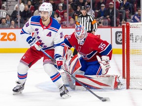 Canadiens' Sam Montembault keeps an eye on New York Rangers' Chris Kreider during the second period of a National Hockey League game in Montreal Thursday March 9, 2023.
