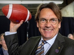 Quebecor CEO Pierre-Karl Péladeau makes like a quarterback after being introduced as new owner of the Montreal Alouettes at a news conference in Montreal on March 10, 2023.