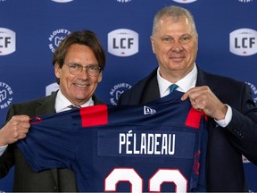 Quebecor CEO Pierre Karl Péladeau is presented with a Montreal Alouettes jersey by Canadian Football League commissioner Randy Ambrosie after being introduced as new owner of the the team at a news conference in Montreal on March 10, 2023.