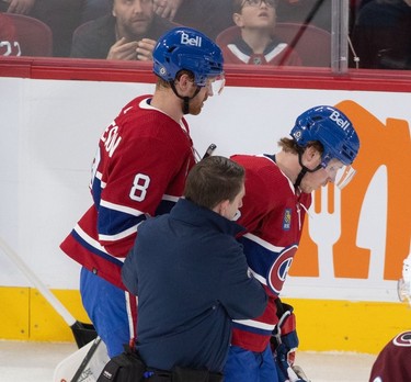 Montreal Canadiens centre Rem Pitlick (32) is escorted off ice after a boarding penalty was called against Colorado Avalanche defenceman Devon Toews during first-period NHL action at the Bell Centre in Montreal on Monday March 13, 2023.
