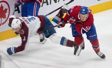 Montreal Canadiens right wing Jesse Ylonen (56) and Colorado Avalanche defenceman Jack Johnson (3) lock skates during first-period NHL action at the Bell Centre in Montreal on Monday March 13, 2023.