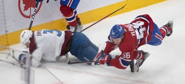 Montreal Canadiens right wing Jesse Ylonen (56) trips over the skate of Colorado Avalanche defenceman Jack Johnson (3) during first-period NHL action at the Bell Centre in Montreal on Monday March 13, 2023.