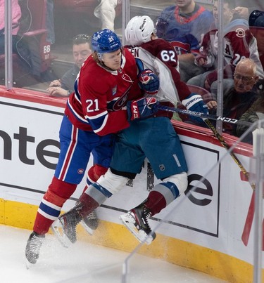 Montreal Canadiens defenceman Kaiden Guhle (21) checks Colorado Avalanche left wing Artturi Lehkonen (62) into the boards during first-period NHL action at the Bell Centre in Montreal on Monday March 13, 2023.