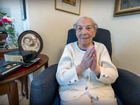 Margaret Romans is seen with a photo from her wedding day with husband Heinrich next to her chair in her room at the Château Pierrefonds seniors residence on Monday, March 13, 2023. She turns 111 on Thursday, March 16.