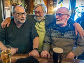 Hurley's owner Bill Hurley visits with regulars Deegan Stubbs, left, and Dan O'Malley in his Crescent St. pub Montreal Wednesday March 15, 2023. This will be Hurley's 30th St. Patrick's Day.