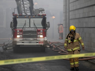 Montreal firefighters at scene of fire on du Port St. in Old Montreal March 16, 2023.