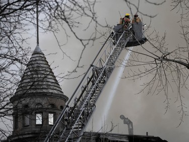 Montreal firefighters at scene of fire on du Port St. in Old Montreal March 16, 2023.