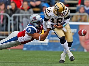 Montreal Alouettes rush-end John Bowman froces a fumble from Winnipeg Blue Bombers quarterback Michael Bishop during game in Montreal on Nov. 1, 2009.