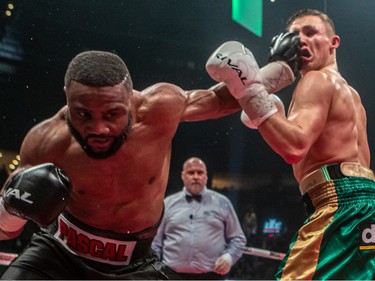 Jean Pascal of Laval delivers a punch to Michael "Diesel" Eifert, right, during their 12-round fight at Place Bell in Laval on Thursday, March 16, 2023.