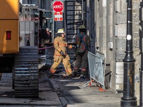 Firefighters continue to investigate the scene of the fire in Old Montreal on Monday March 20, 2023. Dave Sidaway / Montreal Gazette