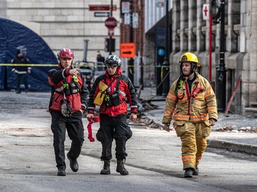Firefighters continue to investigate the scene of the fire in Old Montreal on Tuesday March 21, 2023. Dave Sidaway / Montreal Gazette