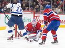 Canadiens goaltender Sam Montembeault saves a shot by the Lightning's Corey Perry as defenceman Chris Wideman provides support during second period Tuesday night at the Bell Centre.