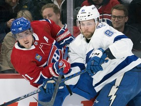 Canadiens' Brendan Gallagher jostles along the boards with the Lightning's Erik Cernak during second period Tuesday night at the Bell Centre.