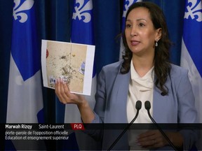 Liberal MNA and education critic Marwah Rizqy displays a photo from a Quebec school showing mouse excrement on a floor. Another photo showed a mouse trap.