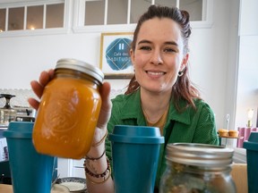 Joanna Nisenbaum, owner of Café des Habitudes, with take-out mason jars of soup and mugs from La Tasse Bleue.