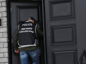 Police officers were busy going in and out of the home of Michel Lamontagne, a Hells Angel member, in Blainville on Wednesday.