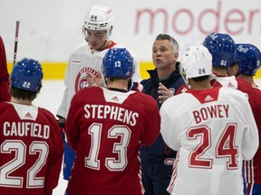 Montreal Canadiens head coach Martin St-Louis talks with his players during the first day of training camp in Brossard on Sept. 22, 2022.