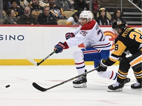 Montreal Canadiens' Denis Gurianov attempts a shot as Marcus Pettersson of the Pittsburgh Penguins defends during the second period in Pittsburgh on March 14, 2023.