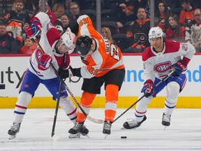 Sean Farrell #57 of the Montreal Canadiens battles with Kieffer Bellows #20 of the Philadelphia Flyers in the first period at the Wells Fargo Center on March 28, 2023 in Philadelphia, Pennsylvania.