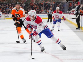 Sean Farrell #57 of the Montreal Canadiens controls the puck against Kevin Hayes #13 of the Philadelphia Flyers in the first period at the Wells Fargo Center on March 28, 2023 in Philadelphia, Pennsylvania.