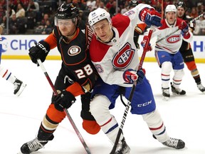 The Ducks’ Frank Vatrano (left) and the Canadiens’ Rem Pitlick battle for puck during second period of Friday night’s game at the Honda Center in Anaheim.