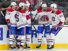 Alex Belzile (60) of the Montreal Canadiens celebrates with teammates after scoring a goal during the third period against the Vegas Golden Knights at T-Mobile Arena in Las Vegas on March 5, 2023.