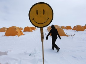 Canada is among the world’s happiest countries, so could happiness have something to do with being cold, columnist Josh Freed asks. Above: A happy face is seen near the tents where researchers live at Summit Station on July 11, 2013 on the Glacial Ice Sheet, Greenland.