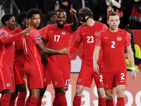 Canada forward Cyle Larin (17) celebrates his goal against Honduras with teammates during first half CONCACAF Nations League soccer action in Toronto.