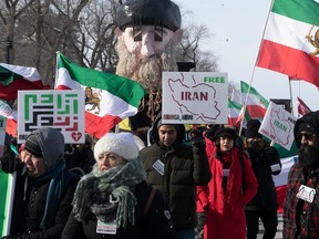 People march from the George-Étienne Cartier monument on Saturday Feb. 4, 2023 to show their solidarity with the women of Iran.