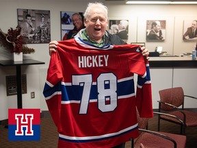 Pat Hickey holds up a Montreal Canadiens jersey during a ceremony in his honour before covering his final Canadiens home game on Feb. 25, 2023.