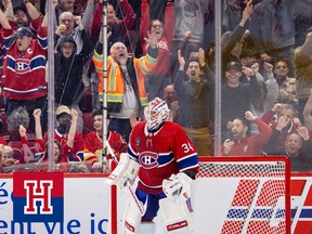Montreal Canadiens fans celebrate after goalie Jake Allen stopped Nazem Kadri of the Calgary Flames to win the game in a shootout on Dec. 12, 2022.