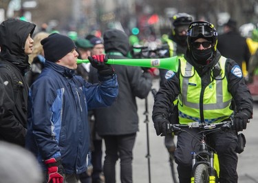 Nick Pfund blows his horn during the St. Patrick's Parade in Montreal on March 19, 2023.