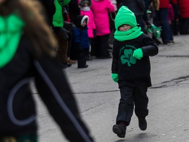 A youngster from the Moran Academy of Irish dancing was bundled up against the cold during the St. Patrick's Day Parade in Montreal Sunday, March 19, 2023.
