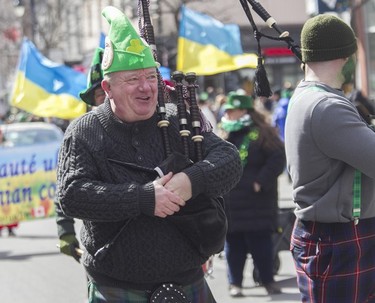 Pipe major Robert McCarthy of the Ottawa Caledonian Pipes and Drums found keeping his hands warm a challenge during the St. Patrick's Parade in Montreal on March 19, 2023.