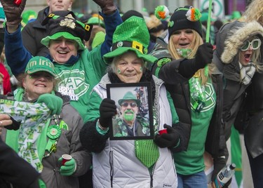 Coleen Kelly holds of photo of her son, Eugene Guitard, who passed away in January and who always attended the St. Patrick's Day Parade in Montreal. Thousands of Montrealers attended the 2023 edition on March 19.