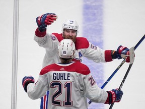 Montreal Canadiens defenceman David Savard congratulates Kaiden Guhle after his goal against the San Jose Sharks during the third period in San Jose, Calif., on Feb. 28, 2023.