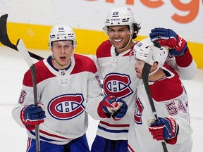 Montreal Canadiens right wing Jesse Ylonen, left, celebrates with defensemen Johnathan Kovacevic and Jordan Harris, right, after scoring a goal against the San Jose Sharks during the third period of an NHL hockey game in San Jose, Calif., Tuesday, Feb. 28, 2023.