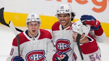 Montreal Canadiens right wing Jesse Ylonen, left, celebrates with defensemen Johnathan Kovacevic and Jordan Harris, right, after scoring a goal against the San Jose Sharks during the third period of an NHL hockey game in San Jose, Calif., Tuesday, Feb. 28, 2023.