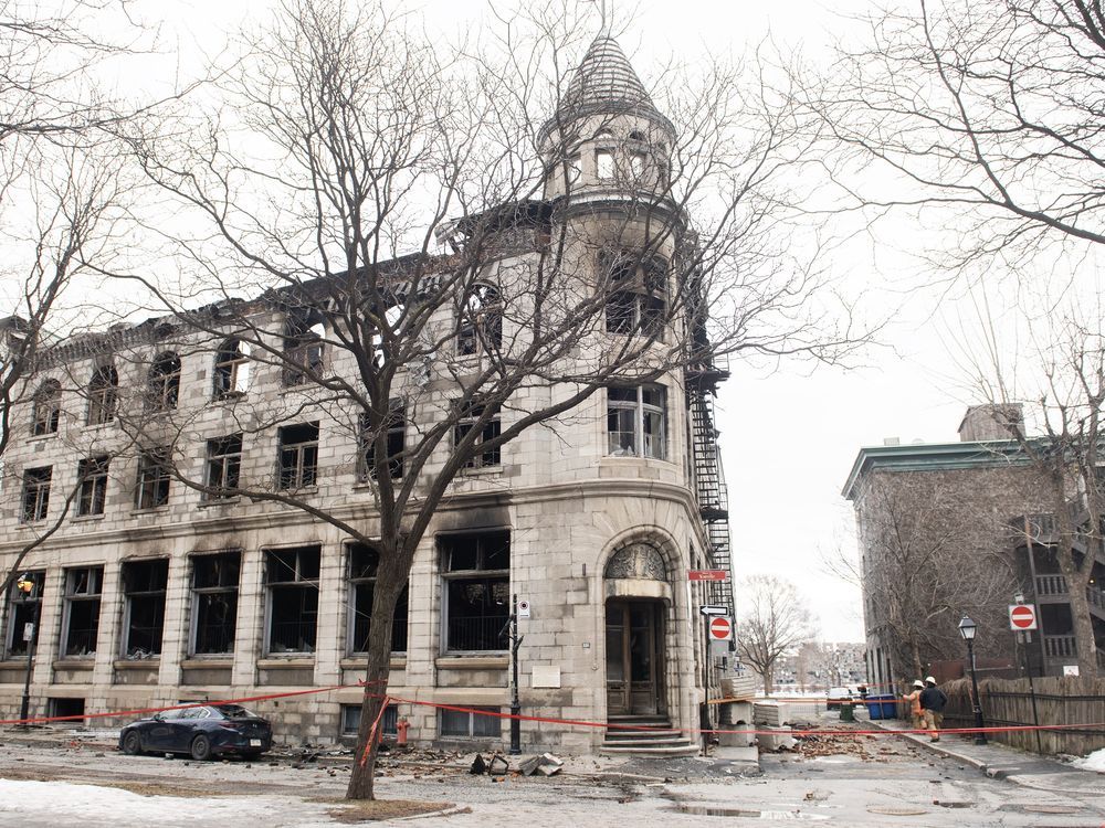 Investigators and firefighters are shown at the scene following a fire in Old Montreal, Saturday, March 18, 2023, that gutted the heritage building.
