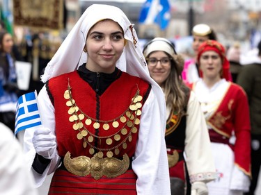 Parade participants march along Jean-Talon St. during the Greek Independence Day celebrations in Montreal on Sunday, March 26, 2023.