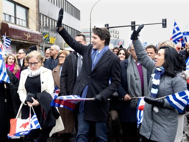 Canadian Prime Minister Justin Trudeau is joined by Montreal Mayor Valérie Plante as they wave to the crowd while marching in the parade during the Greek Independence Day celebrations in Montreal on Sunday, March 26, 2023.