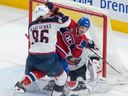 Canadiens' Rafaël Harvey-Pinard battles Blue Jackets' Kirill Marchenko in front of goaltender Elvis Merzlikins Saturday night at the Bell Centre.