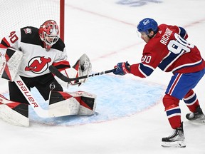 New Jersey Devils goaltender Akira Schmid stops Canadiens' Anthony Richard during first period NHL hockey action in Montreal on Saturday, March 11, 2023.